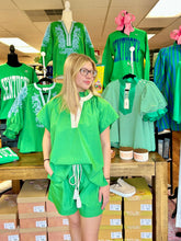 Load image into Gallery viewer, Model wearing a green two piece short outfit set. Shorts have a tie waist. 