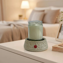 Load image into Gallery viewer, Ceramic warmer with a candle on top.