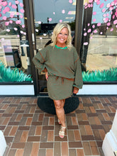 Load image into Gallery viewer, Women’s brown and green striped two-piece sweater set with relaxed long-sleeve top and matching drawstring skort.