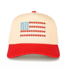 Load image into Gallery viewer, Beige and red cap with a pattern resembling the American flag on a white background
