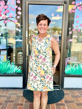 Load image into Gallery viewer, Woman in a floral denim dress.