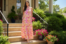 Load image into Gallery viewer, Woman wearing a floral dress.